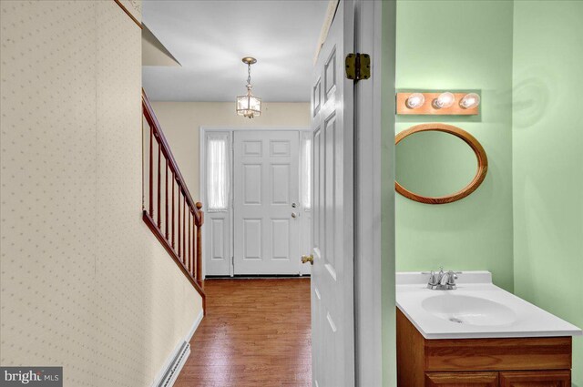 entryway featuring stairway, wallpapered walls, and dark wood-style floors
