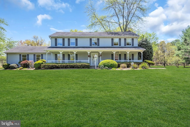 view of front of house with a porch and a front yard