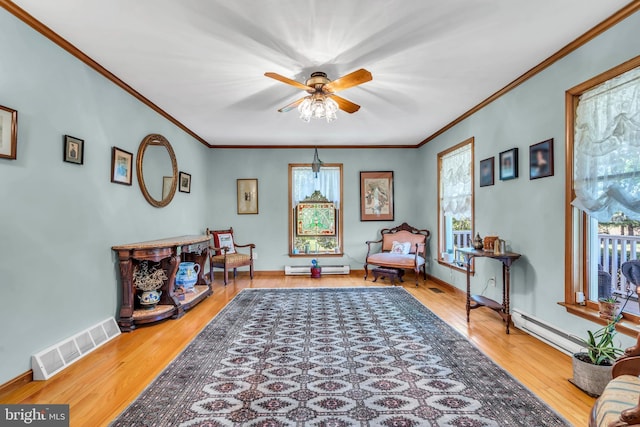 sitting room featuring visible vents, a ceiling fan, a wealth of natural light, and ornamental molding