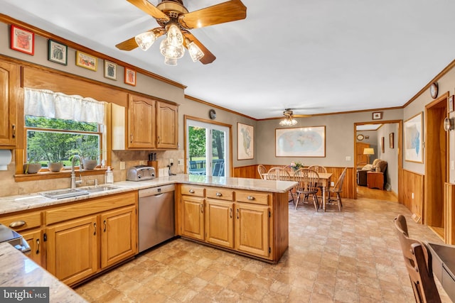 kitchen with stone finish floor, ceiling fan, stainless steel dishwasher, a peninsula, and ornamental molding