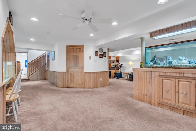 interior space with recessed lighting, carpet flooring, a ceiling fan, and a wainscoted wall