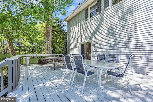 wooden deck featuring outdoor dining area
