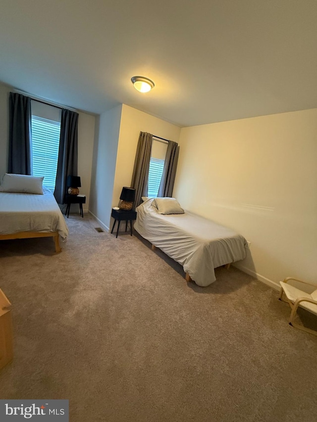 bedroom featuring baseboards and carpet floors