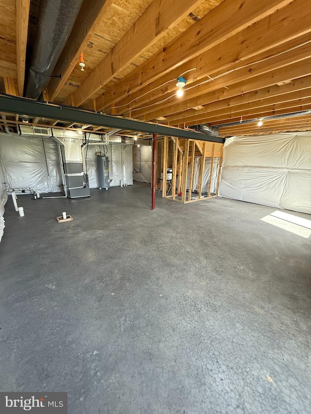unfinished below grade area featuring water heater