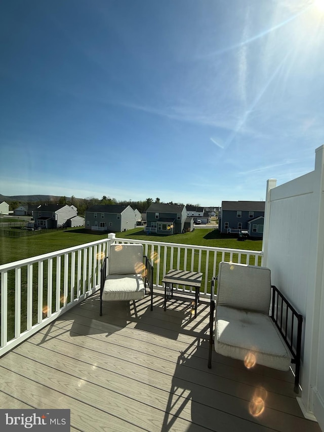 deck featuring a yard and a residential view