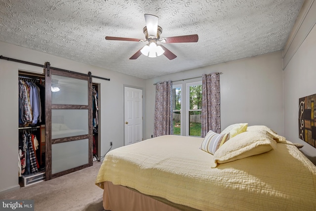7815 Shallowbrook Ct, Severn, MD 21144 - carpeted bedroom with ceiling fan, a closet, a barn door, and a textured ceiling