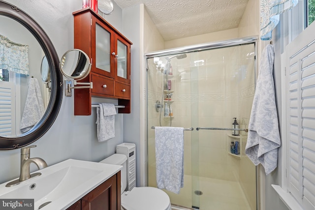 7815 Shallowbrook Ct, Severn, MD 21144 - full bathroom with a stall shower, vanity, toilet, and a textured ceiling