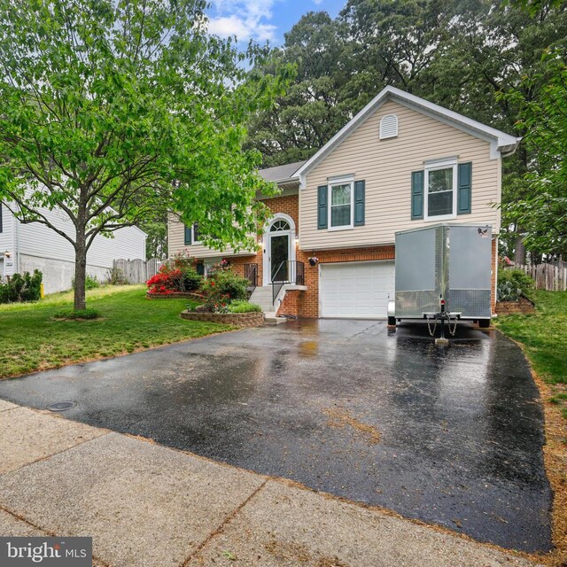 7815 Shallowbrook Ct, Severn, MD 21144 - raised ranch with fence, an attached garage, brick siding, driveway, and a front yard