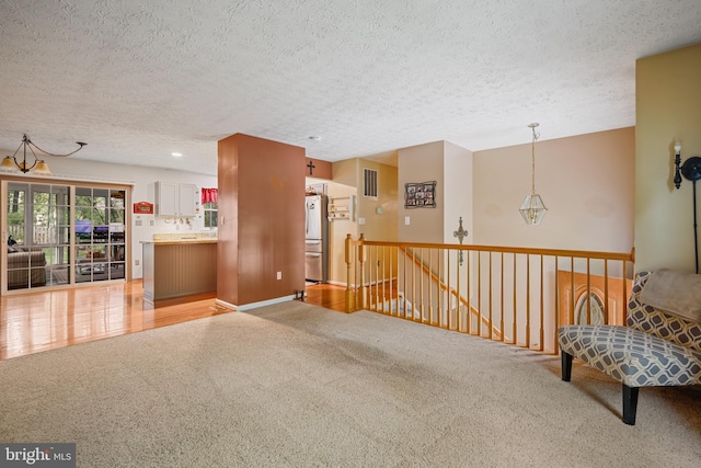 7815 Shallowbrook Ct, Severn, MD 21144 - interior space featuring a textured ceiling, light carpet, an upstairs landing, and visible vents