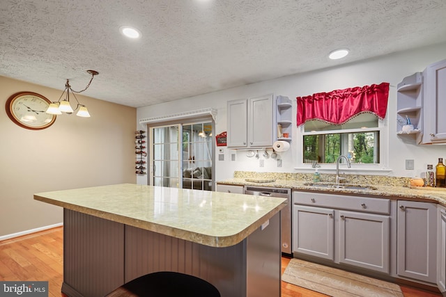 7815 Shallowbrook Ct, Severn, MD 21144 - kitchen featuring light wood-style flooring, a sink, open shelves, a textured ceiling, and stainless steel dishwasher