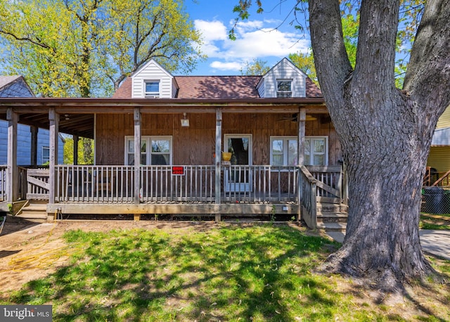 view of front of house with a porch and a front yard