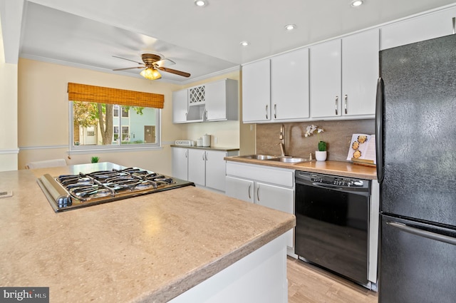 kitchen with white cabinets, ceiling fan, a sink, recessed lighting, and black appliances
