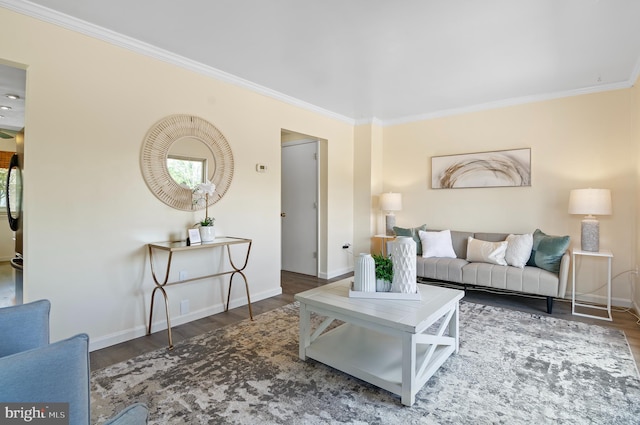 living room with crown molding, baseboards, and wood finished floors