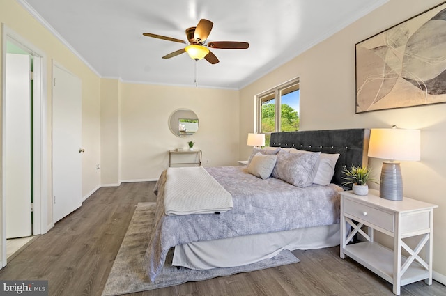 bedroom with baseboards, ceiling fan, ornamental molding, and wood finished floors