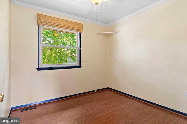 spare room featuring visible vents, ornamental molding, wood finished floors, baseboards, and ceiling fan