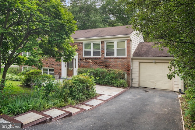 1806 Cranberry Ln, Reston, VA 20191 - view of front of house with brick siding, asphalt driveway, a garage, and roof with shingles