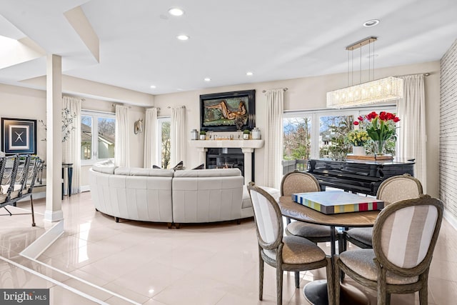 living area featuring recessed lighting, a glass covered fireplace, and light tile patterned floors