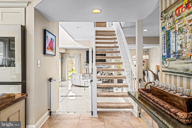 entrance foyer with baseboards, recessed lighting, stairs, and light tile patterned floors
