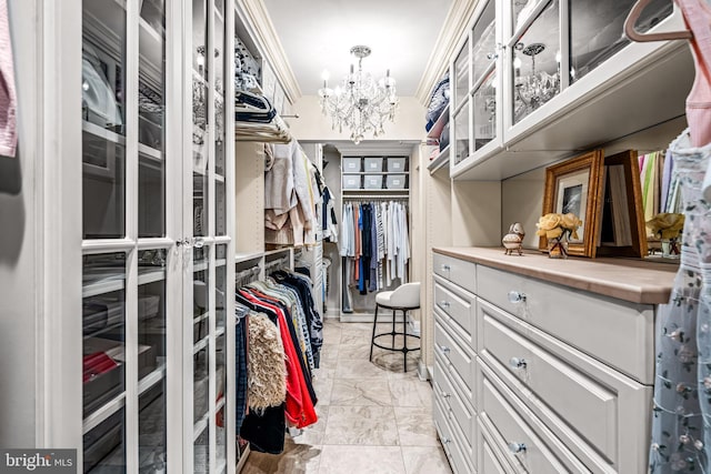 walk in closet featuring an inviting chandelier