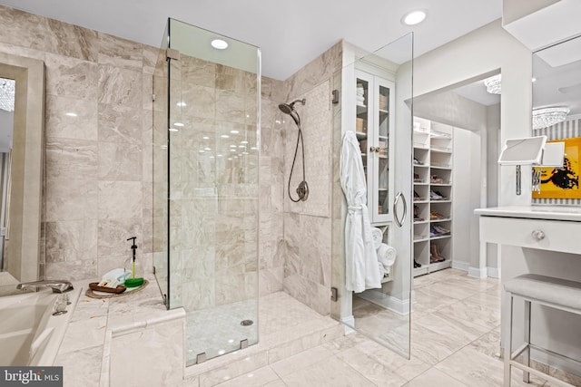 bathroom with a garden tub, a tile shower, marble finish floor, a spacious closet, and recessed lighting