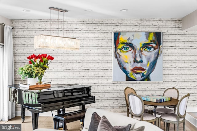 interior space with wood finished floors and brick wall