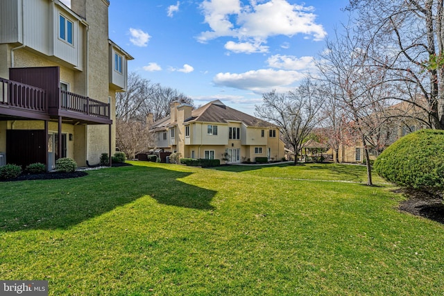 view of home's community with a residential view, a lawn, and a deck
