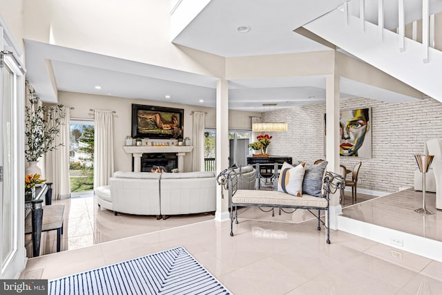 living area featuring a glass covered fireplace, light tile patterned floors, and recessed lighting