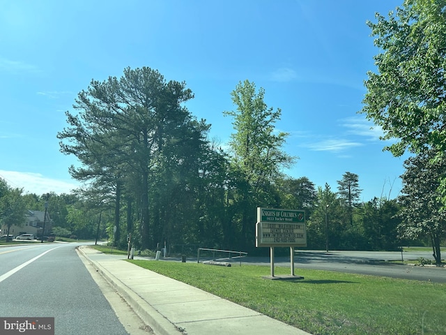 view of road with sidewalks and curbs
