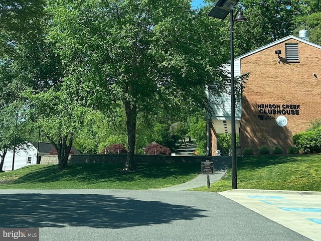 view of sport court with a yard