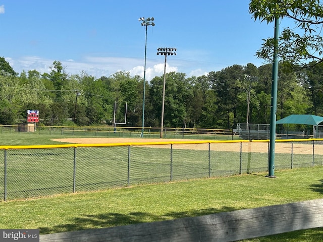 exterior space featuring volleyball court, fence, and a yard