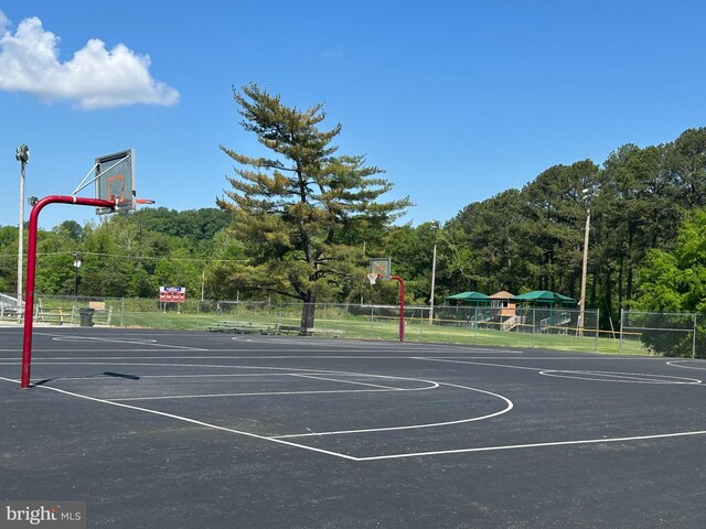 view of basketball court with fence and community basketball court