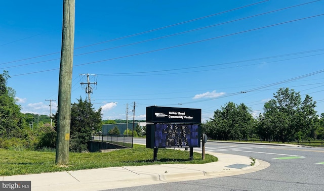 view of road with sidewalks and curbs