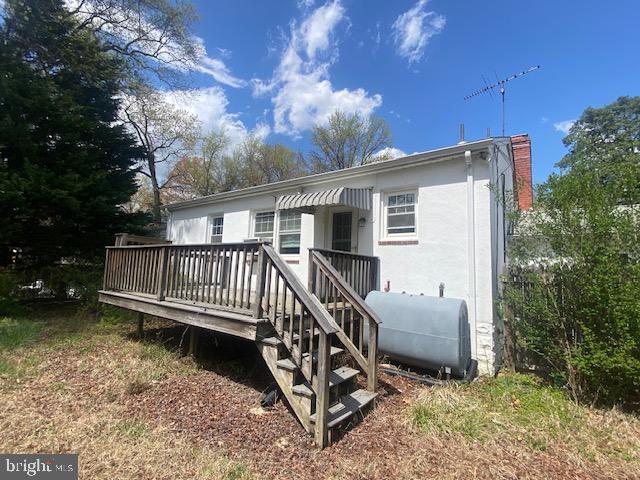 rear view of property featuring heating fuel and a deck