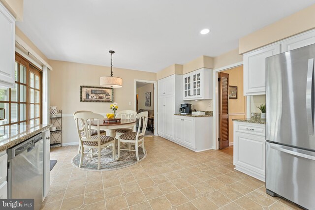 dining room with recessed lighting and baseboards