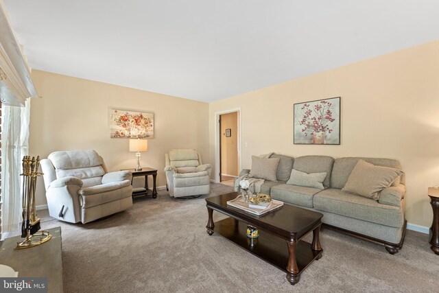 carpeted living area with baseboards