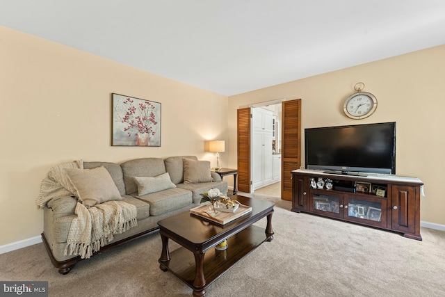 carpeted living room featuring baseboards