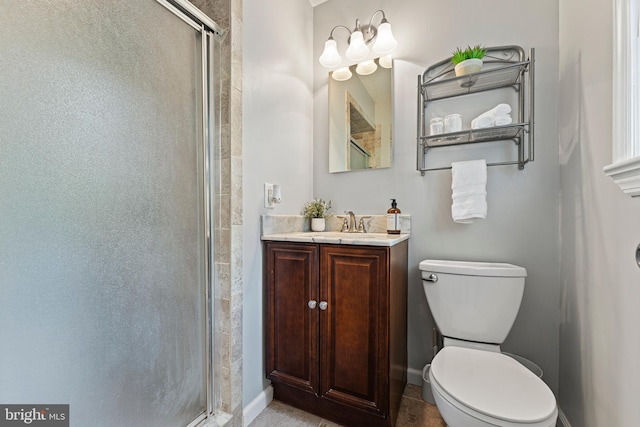 bathroom with vanity, baseboards, a shower stall, and toilet