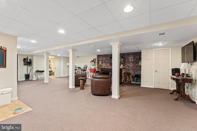 finished basement with baseboards, carpet flooring, a paneled ceiling, and visible vents