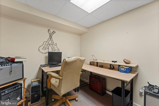 office featuring baseboards and a drop ceiling