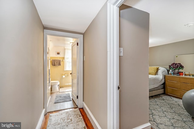 corridor featuring wood finished floors
