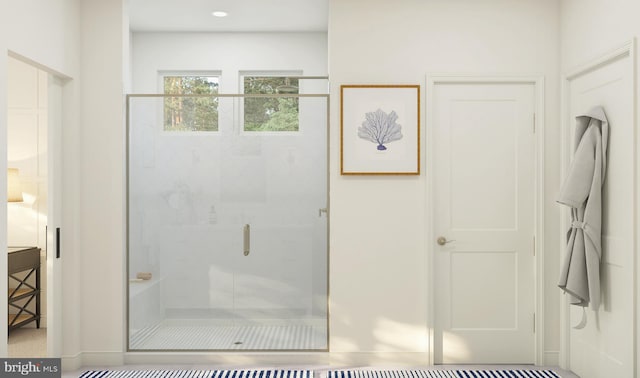 bathroom with baseboards and a stall shower