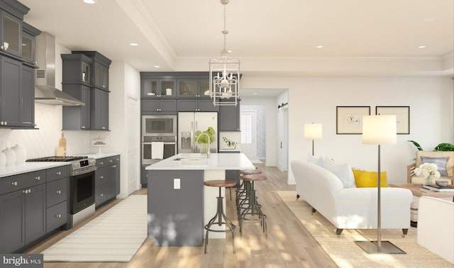 kitchen with an inviting chandelier, a sink, stainless steel appliances, decorative backsplash, and light wood-type flooring