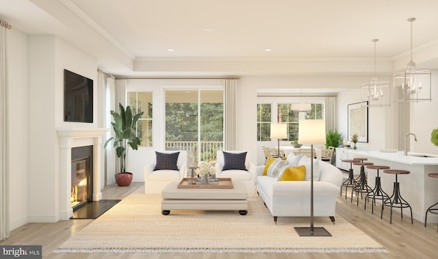 living area with crown molding, recessed lighting, a fireplace with flush hearth, and light wood-style floors