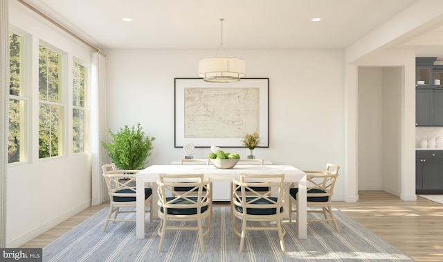 dining space with light wood-type flooring, recessed lighting, and baseboards