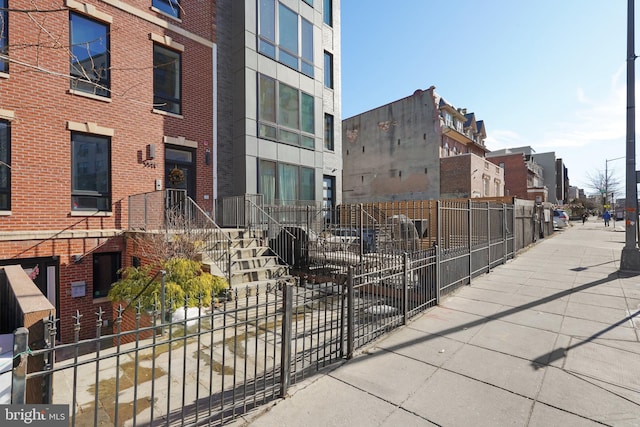 exterior space featuring fence and a residential view