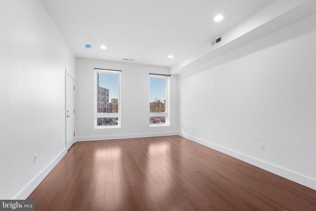 unfurnished room with recessed lighting, baseboards, visible vents, and wood finished floors