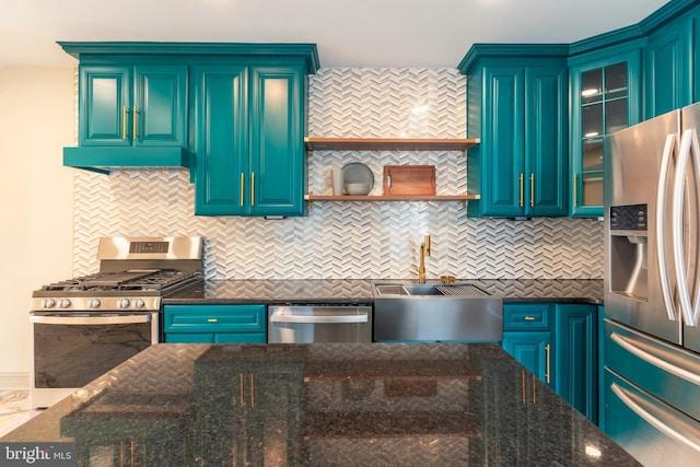 kitchen with a sink, dark stone countertops, stainless steel appliances, tasteful backsplash, and glass insert cabinets