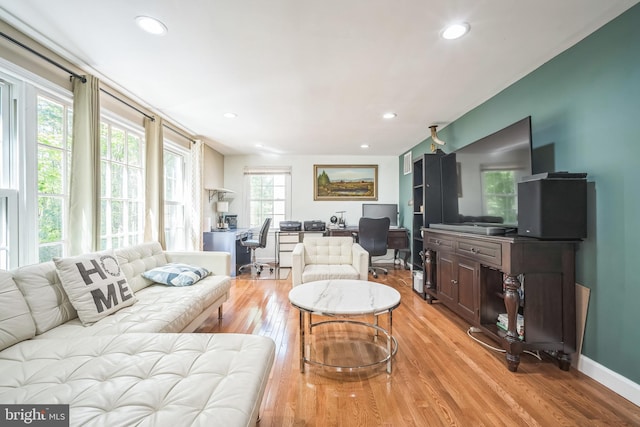 living room featuring light wood-style floors, recessed lighting, and baseboards