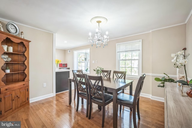 dining space with light wood-style floors, baseboards, and a chandelier
