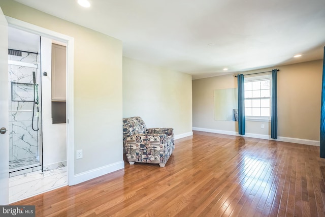 unfurnished room with light wood-type flooring, recessed lighting, and baseboards